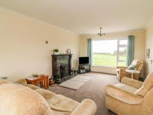 a living room with two couches and a fireplace at Findale in Wexford