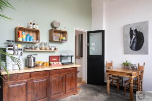 a kitchen with a wooden counter with a table and a table sidx sidx at B&B Het Oude Postkantoor in Yerseke
