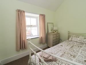 a bedroom with a bed and a window at Preswylfa in Betws-y-coed