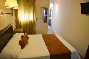 Postel nebo postele na pokoji v ubytování Hotel Los Cedros