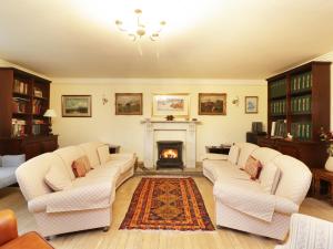 sala de estar con 2 sofás y chimenea en Tulchan Lodge, en Buchanty