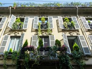 a row of windows on a building with plants at Antica Locanda Dei Mercanti in Milan
