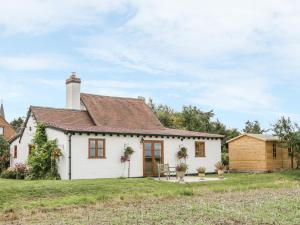 a white cottage with a red roof at Little Pound House in Mamble