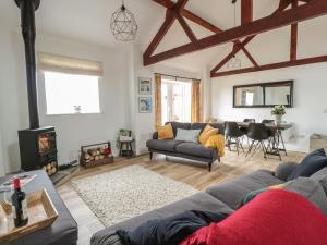 a living room with a couch and a fireplace at The Stable in Berkeley