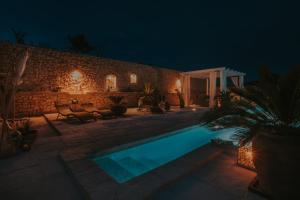 a swimming pool in a yard at night at The Residence in Šibenik