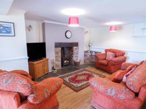 a living room with two couches and a fireplace at Arfryn in Bethesda