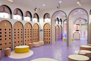 a room with arched doors and tables and chairs at The Qube Hotel Shanghai Sanjiagang - Offer Pudong International Airport and Disney shuttle in Shanghai