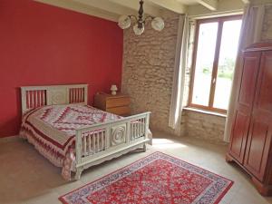 a bedroom with a white bed and a window at Gite les Fleurs in Eymet