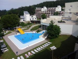 an overhead view of a large swimming pool with chairs at Wellness Apartment Sankt Englmar in Sankt Englmar