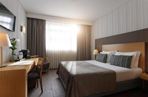 Ein Bett oder Betten in einem Zimmer der Unterkunft Mercure Lisboa Almada