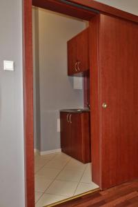 an open door to a kitchen with a cupboard at Teatr Baj Pomorski in Toruń