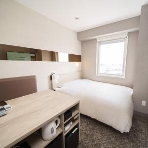 Postel nebo postele na pokoji v ubytování Super Hotel Saitama Kawagoe