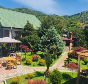 a view of a garden with a table and chairs at Vacation Home Nukri in Gonio