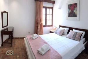 A bed or beds in a room at Pyrgi Spetses