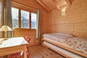1 dormitorio con 1 cama en una cabaña de madera en Comfortable chalet in the heart of nature, calm and peaceful en Saint-Luc
