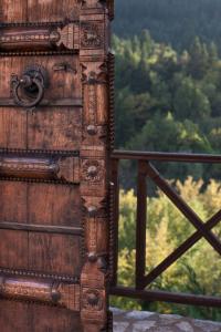 a close up of a wooden door with trees in the background at Μαγεμένο Βουνό in Karpenisi
