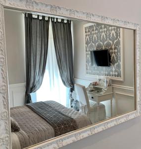 a hotel room with a bed and a mirror at Charme & Chic in Rome