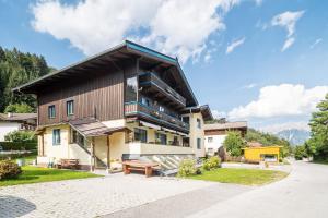 a house in the mountains with a patio at Ferienhaus Sonnrain in Leogang