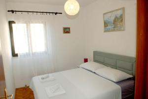 En eller flere senge i et værelse på Apartments Villa Tanja