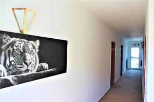 a picture of a tiger on a wall at Hotel Alsterquelle in Henstedt-Ulzburg