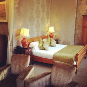 um quarto de hotel com duas camas e duas cadeiras em Fountain Inn by Greene King Inns em Cowes