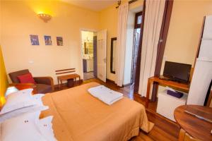 a hotel room with a bed and a television at Les 3 Métis in Antananarivo