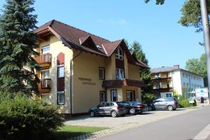 a building with cars parked in a parking lot at Ferienhaus Drobesch in Sankt Kanzian