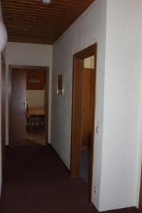 an empty hallway with a door and a dining room at Ferienhaus Drobesch in Sankt Kanzian