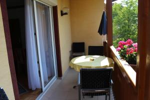 a room with a balcony with a table and a window at Ferienhaus Drobesch in Sankt Kanzian