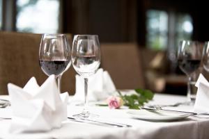 two glasses of wine sitting on a table at Bryne Hotell in Bryne