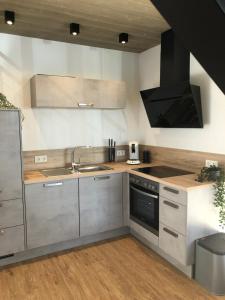 a kitchen with a sink and a stove at BEe HOME - Urlaubs und Business Loft in Kevelaer