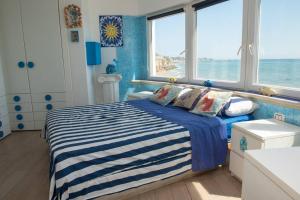 a bedroom with a bed with a view of the ocean at Villa Paola sullo scoglio in Anzio