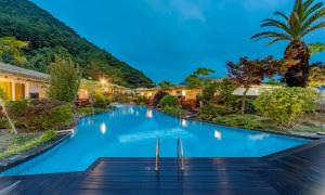 a swimming pool in a resort at night at Tongyeong Hansan Marina Resort in Tongyeong