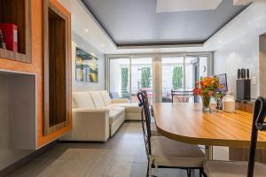a dining room with a table and a couch at Appartement le Saint Simond in Aix-les-Bains +11 photos