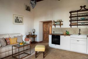 a living room with a couch and a kitchen at Suite Virginia Baglioni in San Michele in Teverina