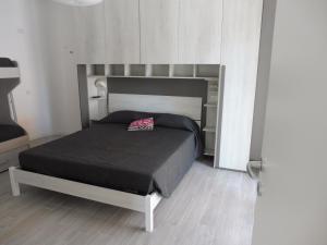 a bedroom with a bed with a black bedspread at Residence Caorle App. n. 5 in Caorle