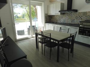a kitchen with a table and chairs in a room at Residence Caorle App. n. 5 in Caorle