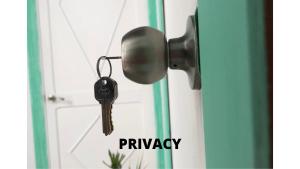 a key hanging from a door with the words privacy at Lion Hostel By Rebels kiteschool in Tarifa