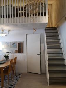 a staircase leading to a room with a table and a door at Apartment Seita in Levi