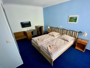 Postel nebo postele na pokoji v ubytování Hotel Rustikal