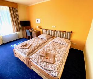 Postel nebo postele na pokoji v ubytování Hotel Rustikal