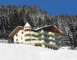 a building on top of a snow covered mountain at Hotel Edelweiß-Schlössl in Kappl