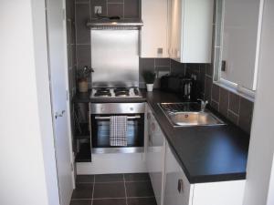 a small kitchen with a stove and a sink at White Horse Studio in Preston