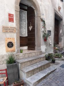 an entrance to a building with stairs leading to a door at Come una volta in Monte Isola