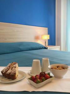- une table avec deux assiettes de nourriture et un bol de fruits dans l'établissement Hotel Conchiglia d'Oro, à Mondello