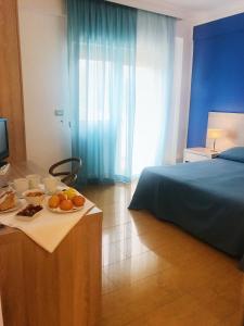 Postel nebo postele na pokoji v ubytování Hotel Conchiglia d'Oro