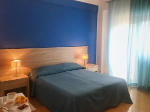 Postel nebo postele na pokoji v ubytování Hotel Conchiglia d'Oro