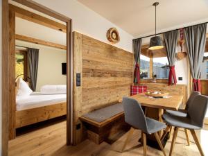 a bedroom with a wooden bed and a wooden chair at Apartments Riega in Sesto