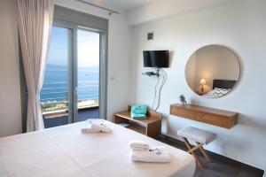 
a hotel room with a view of the ocean at Bay View GuestHouses in Kalamata
