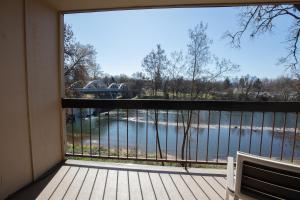 a balcony with a view of a body of water at Riverside Inn in Grants Pass
